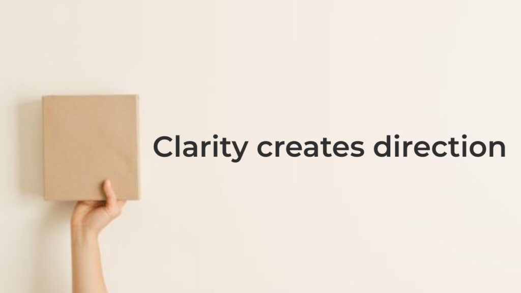 Hand holding a wooden block representing clarity over hustle in digital marketing and clear direction
