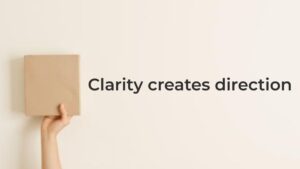 Hand holding a wooden block representing clarity over hustle in digital marketing and clear direction